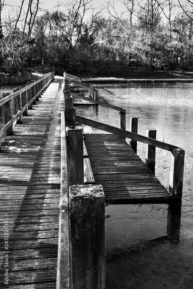 wooden bridge over frozen lake wooden bridge over frozen lake