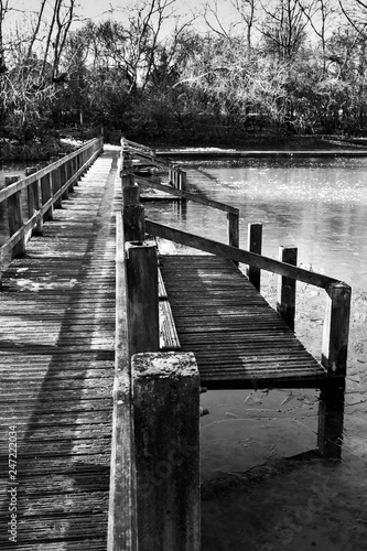 wooden bridge over frozen lake photo