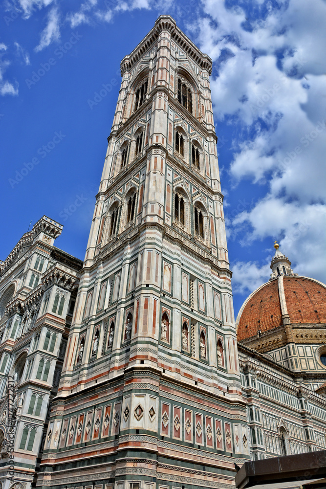 Giotto's Campanile stands adjacent to the Florence Cathedral. It is 84.7 meters tall. The tower has rich sculptural decorations & polychrome marble encrustations. Gothic architecture. Italy, Florence.