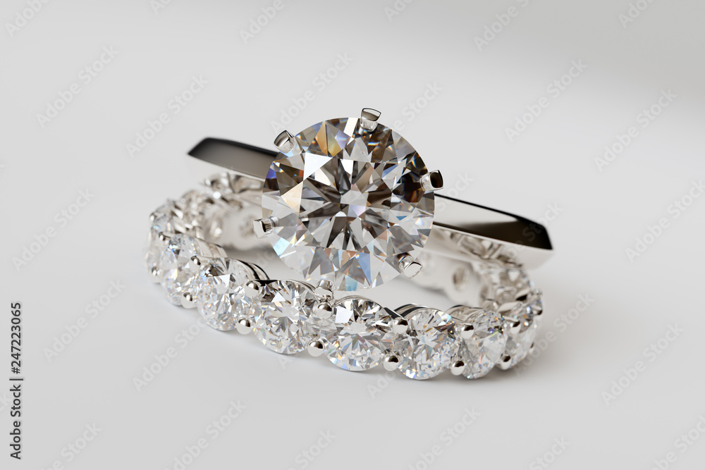 Solitaire diamond engagement ring, eternity wedding band on white background Solitaire diamond engagement ring, eternity wedding band on white background