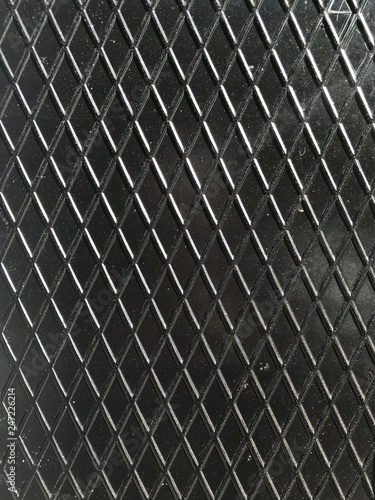 Steel fence grid on black background texture
