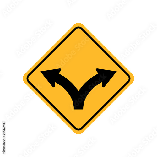 Damaged yellow metallic road sign with fork symbol