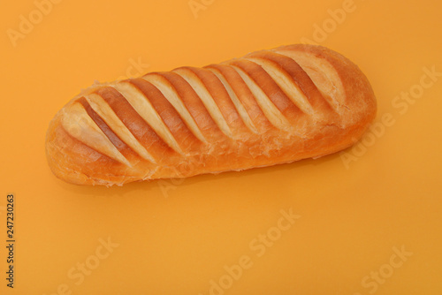 photo of handmade white bread on orange background