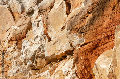 Natural texture of red rocks. Cracked and weathered natural stone background