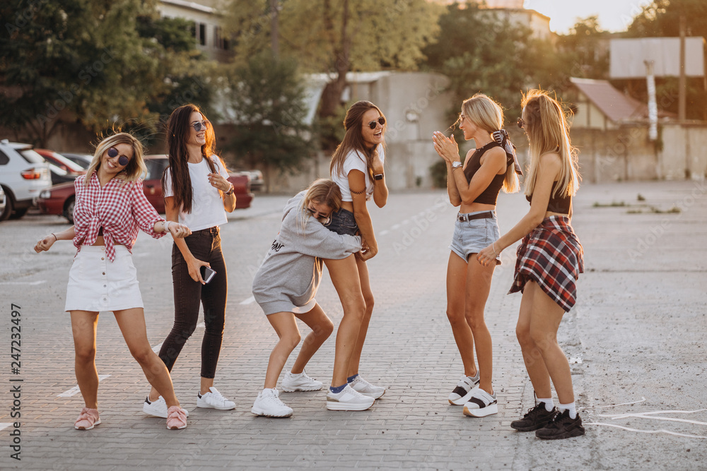 Six young women dance in a car park Six young women dance in a car park