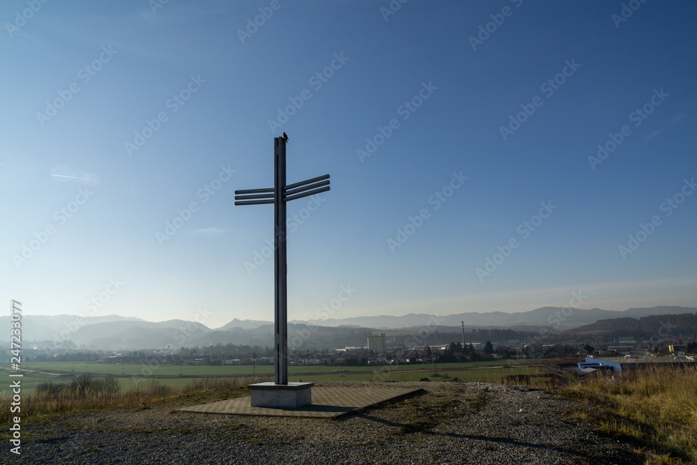 Iron cross statue on the meadow above the city. Zilina, Slovakia