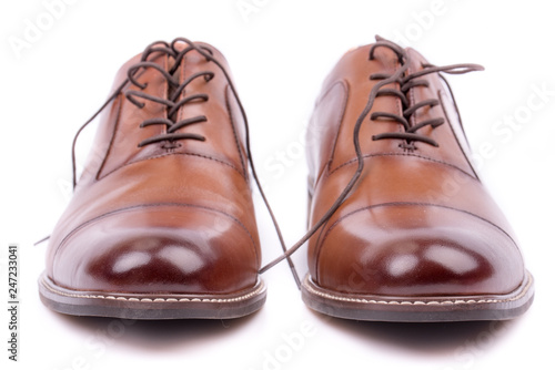 Classic leather elegant shoe on a white background. Beautiful brown luxury and casual leather men shoes. Fashion accessory. Closeup, front view. Both leg. Isolated. 