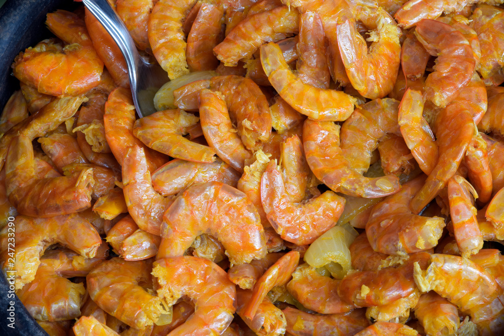 Portion of fried shrimp in clay pan Portion of fried shrimp in clay pan