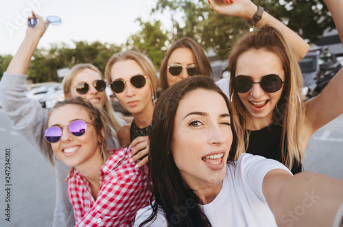 Six young beautiful girls looking at the camera and taking a selfie