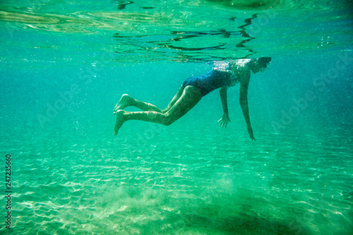 Underwater scene in Ionian sea  Zakynthos  Greece  with girls playing in the water
