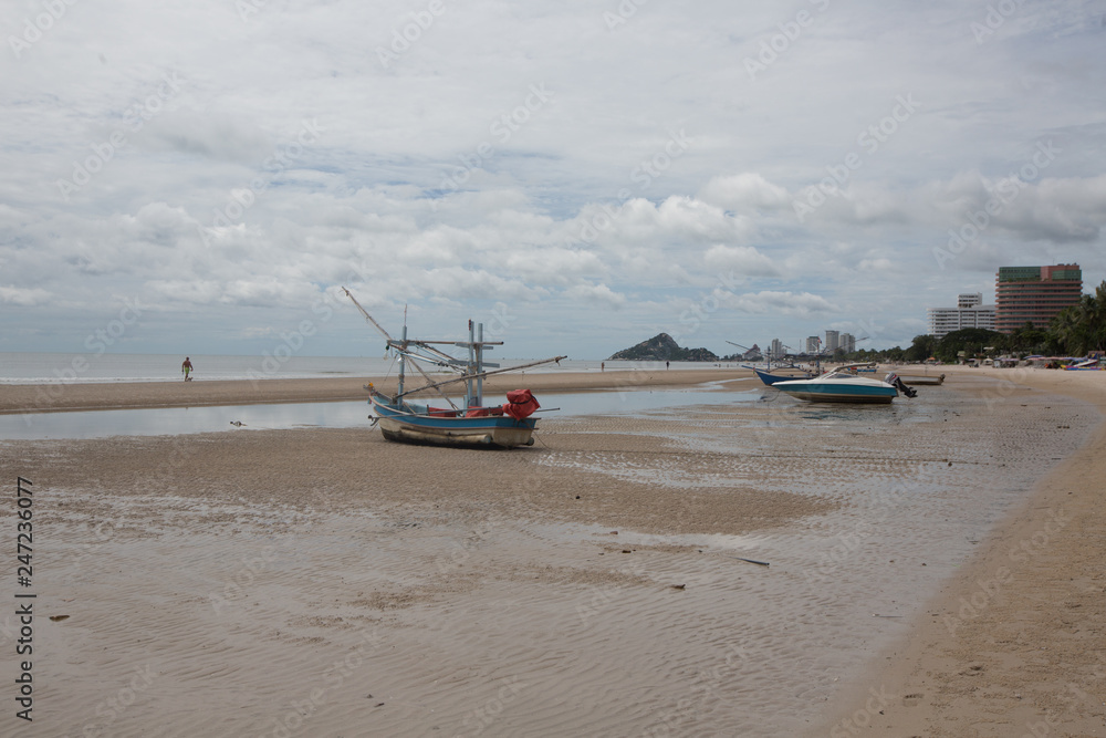 Fishing boats at the beach of Hua HI on a cloudy day, THailand