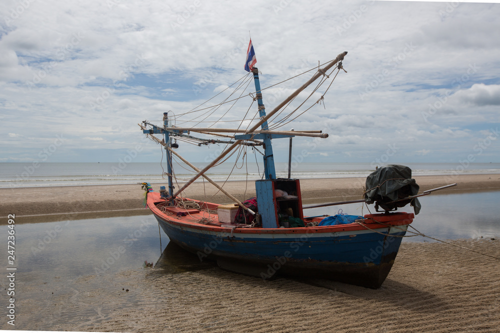 Fishing boat at the beach of Hua HI on a cloudy day, Thailand,