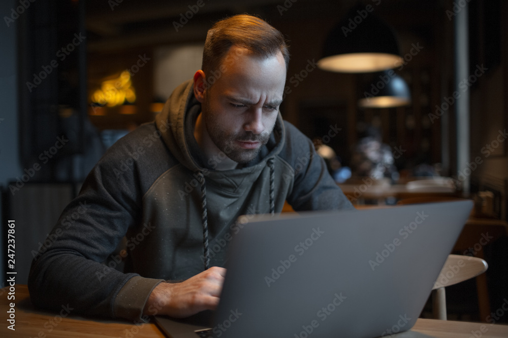 Surprised young man with laptop in cafe. Surprised young man with laptop in cafe.