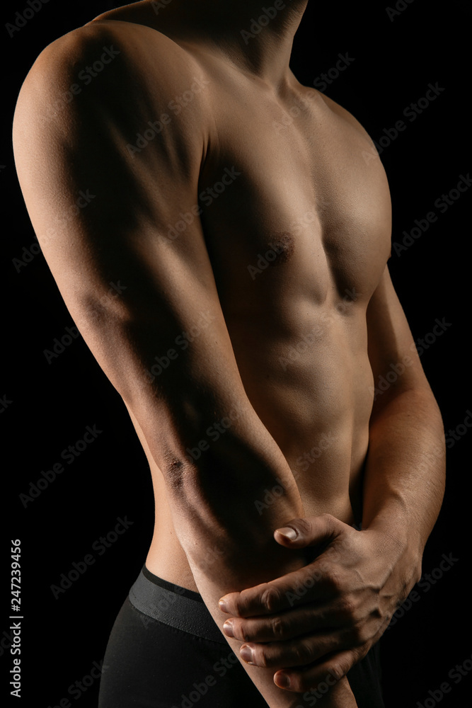 closeup strong male hands and pumped up press. sportman's portrait in a low key closeup strong male hands and pumped up press. sportman's portrait in a low key