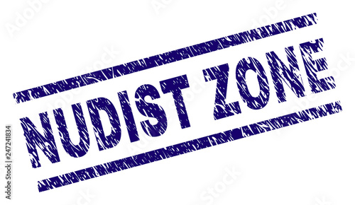 NUDIST ZONE seal print with distress style. Blue vector rubber print of NUDIST ZONE caption with scratched texture. Text title is placed between parallel lines.