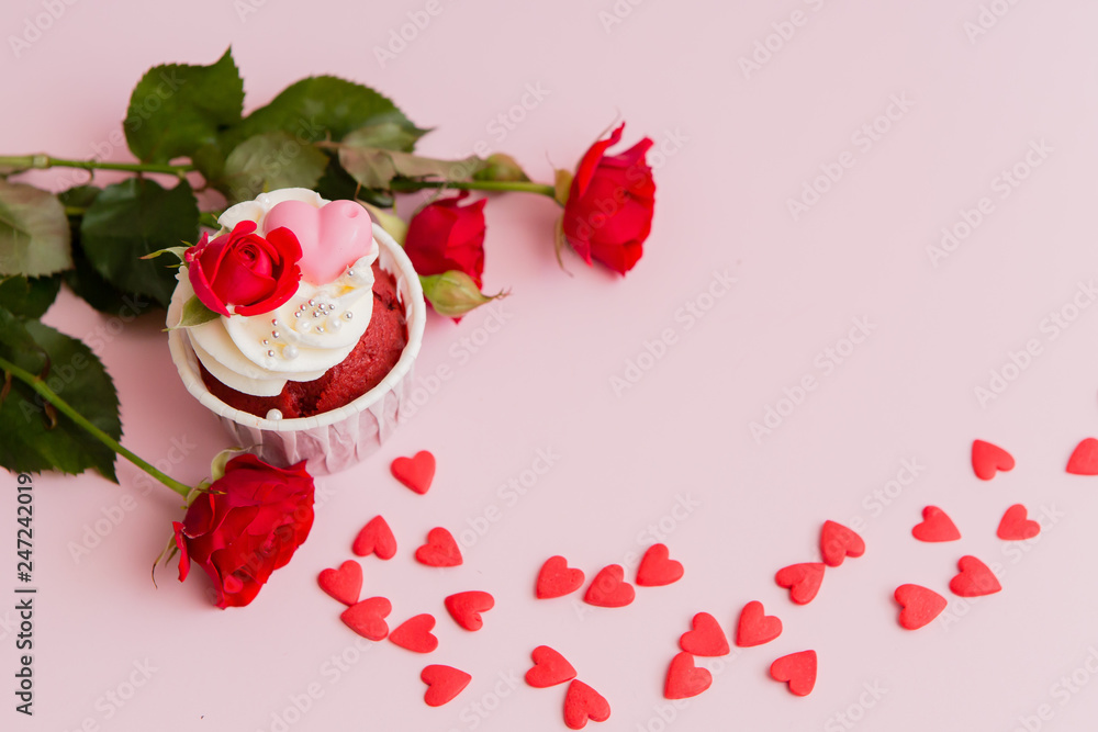 cupcake roses and hearts on a pink background.copy spase.Chocolate cupcakes decorated with cream rose cupcake roses and hearts on a pink background.copy spase.Chocolate cupcakes decorated with cream rose