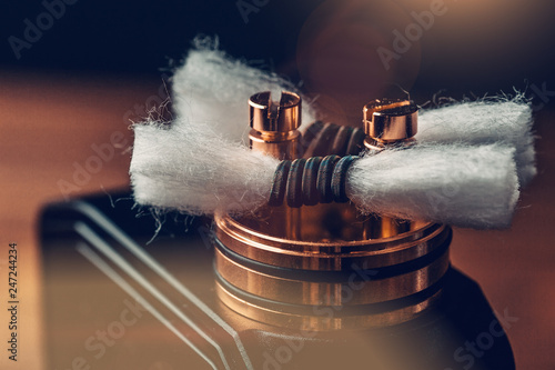 RDA - vape device with Coils and Japanese organic cotton for vaping, close up. E-cigarette or e-cig for alternative smoking photo