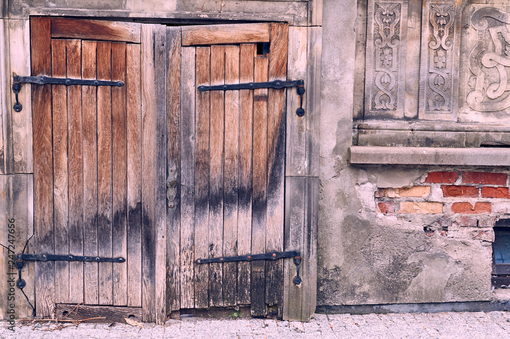 Naklejka premium Old gate made of wood with steel hinges in Gdansk, Poland