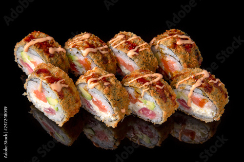 Wallpaper Mural Hot fried Sushi Roll with perch, tobiko caviar, avocado and cheese on black background. Sushi menu. Japanese food.  Torontodigital.ca