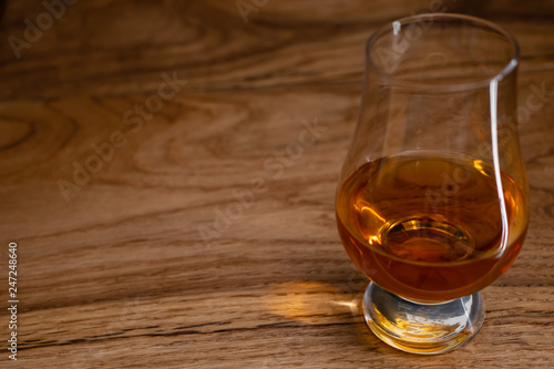 Irish Whiskey in Glencairn Glass on Wooden Background