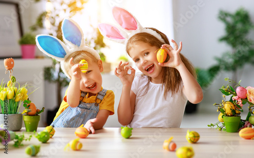 Happy easter! funny funny children   with ears hare getting ready for  holiday