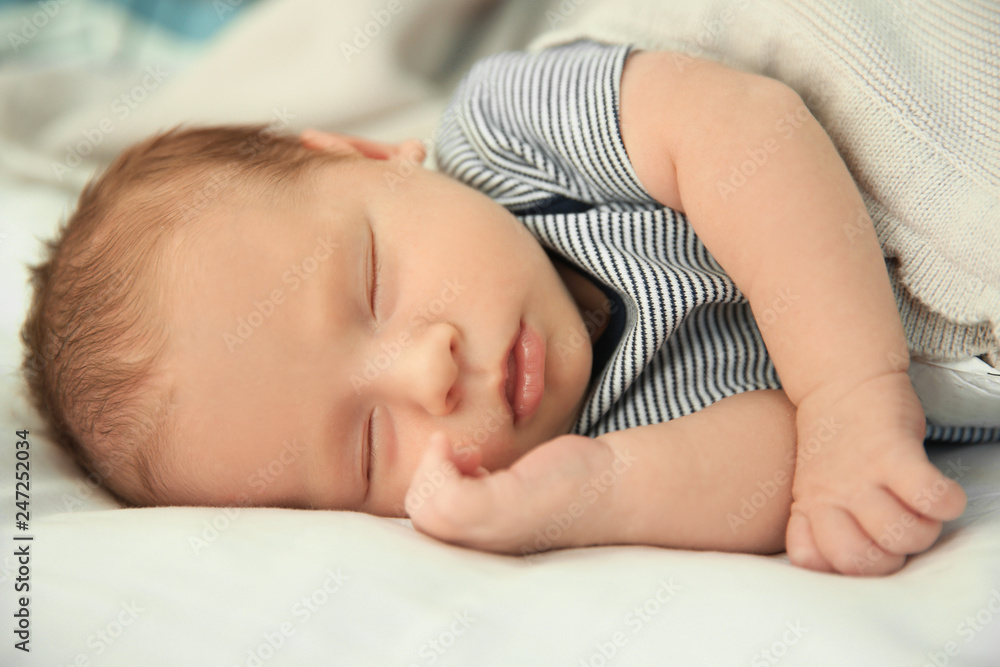 Adorable newborn baby peacefully sleeping on bed Adorable newborn baby peacefully sleeping on bed