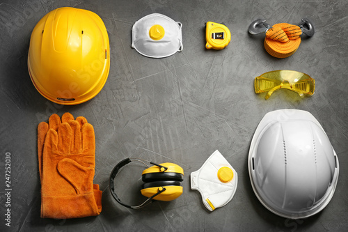 Flat lay composition with safety equipment and space for text on grey background