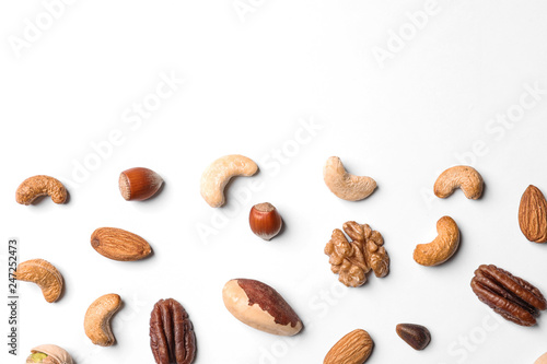 Composition with organic mixed nuts on white background, top view. Space for text