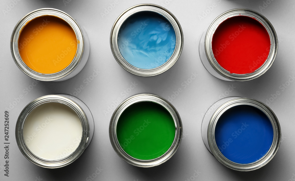 Open paint cans on grey background, top view Open paint cans on grey background, top view