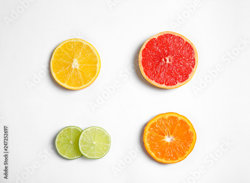 Different citrus fruits on white background  top view