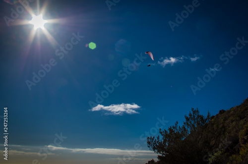 A paraplan in a blue sky photo