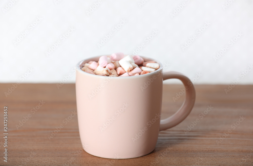 Cup of aromatic cacao with marshmallows on wooden table Cup of aromatic cacao with marshmallows on wooden table