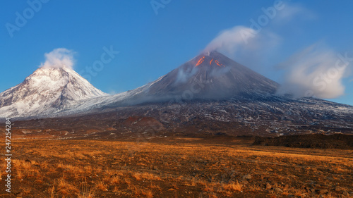 Autumn mountain landscape view at sunrise of eruption active volcano