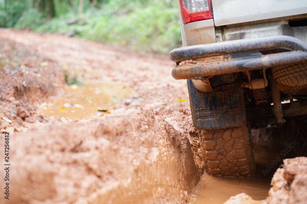 Off-road tires, Dirty offroad car, SUV covered with mud on countryside road. offroad travel and driving concept. Off-road tires, Dirty offroad car, SUV covered with mud on countryside road. offroad travel and driving concept.