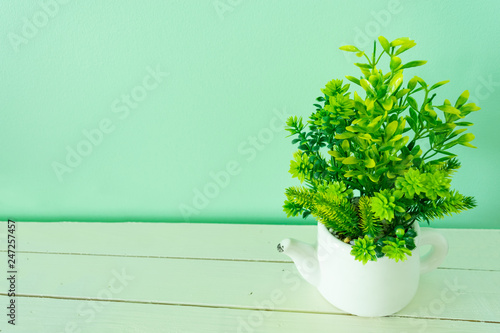 The flower pot on  wooden board have a less space for copy texture backgrounds