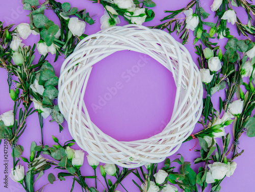 White roses and wreath on purple background