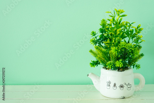 The flower pot on  wooden board have a less space for copy texture backgrounds