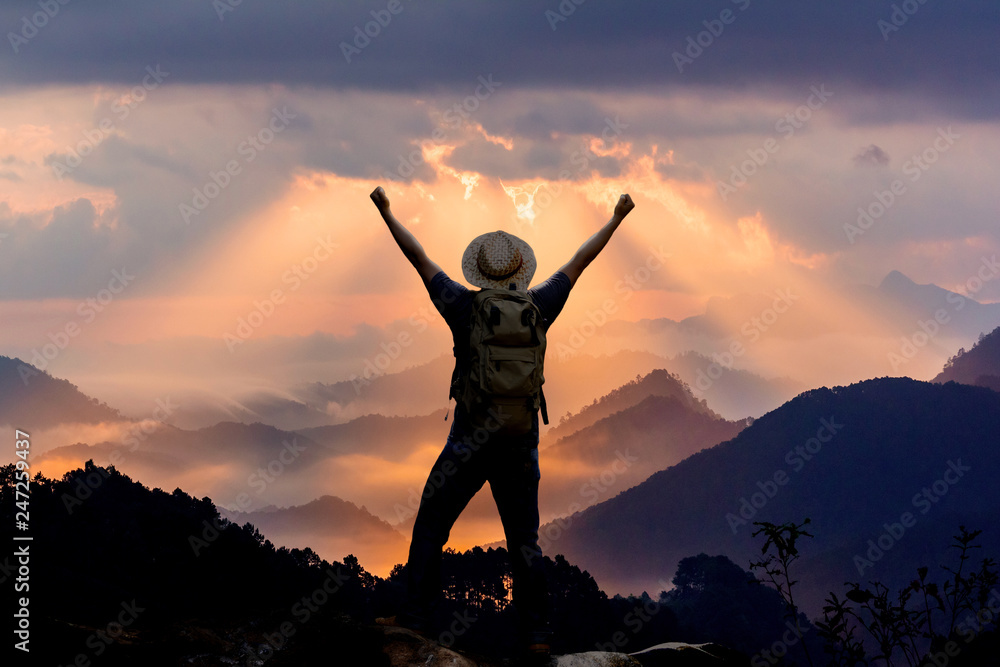 Silhouette of hiker man on top of mountain. successful people concept