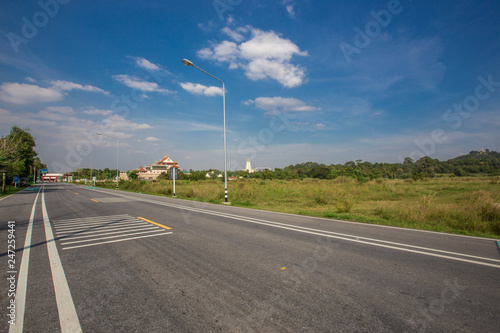 The background of the grass on the roadside and the bright blue sky, is a refreshing atmosphere of good weather.