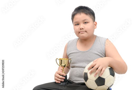 Obese fat boy holding football and trophy photo