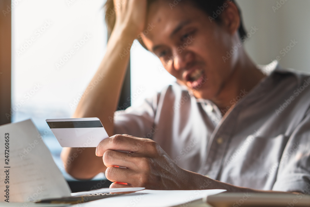 Person exhausted with bankruptcy problem. shocked man carrying bills and credit card on his hands worry about bank notification mail. Person exhausted with bankruptcy problem. shocked man carrying bills and credit card on his hands worry about bank notification mail.