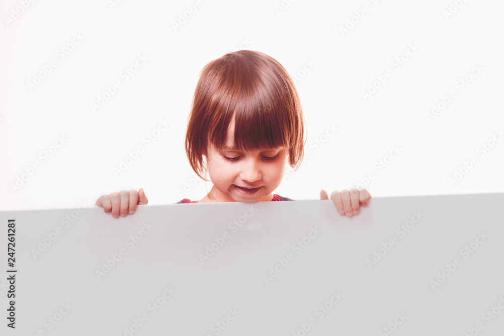Beautiful child girl showing blank white board for advertising to be inserted Beautiful child girl showing blank white board for advertising to be inserted