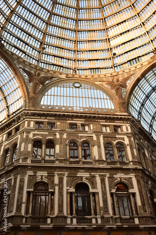 Building and gigantic glass ceiling with two angels and cupola of Galleria Umberto in Naples.
