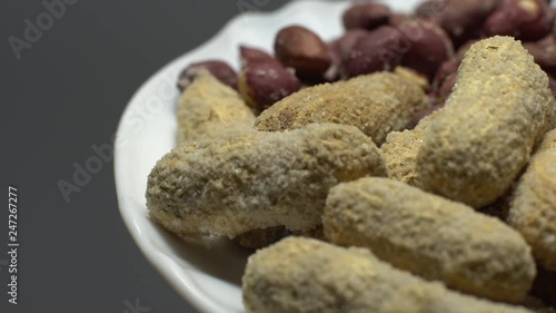 Peanuts. Mixed Peanuts in rotation. Snack closeup.  Peanuts in a bowl. Selective focus. grey background. Studio shot. Healthy food concept.