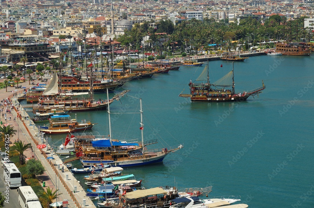 Touristic sailboats setting off to the Mediterranean sea in the ancient port of Alanya city. Antalya, Turkey.