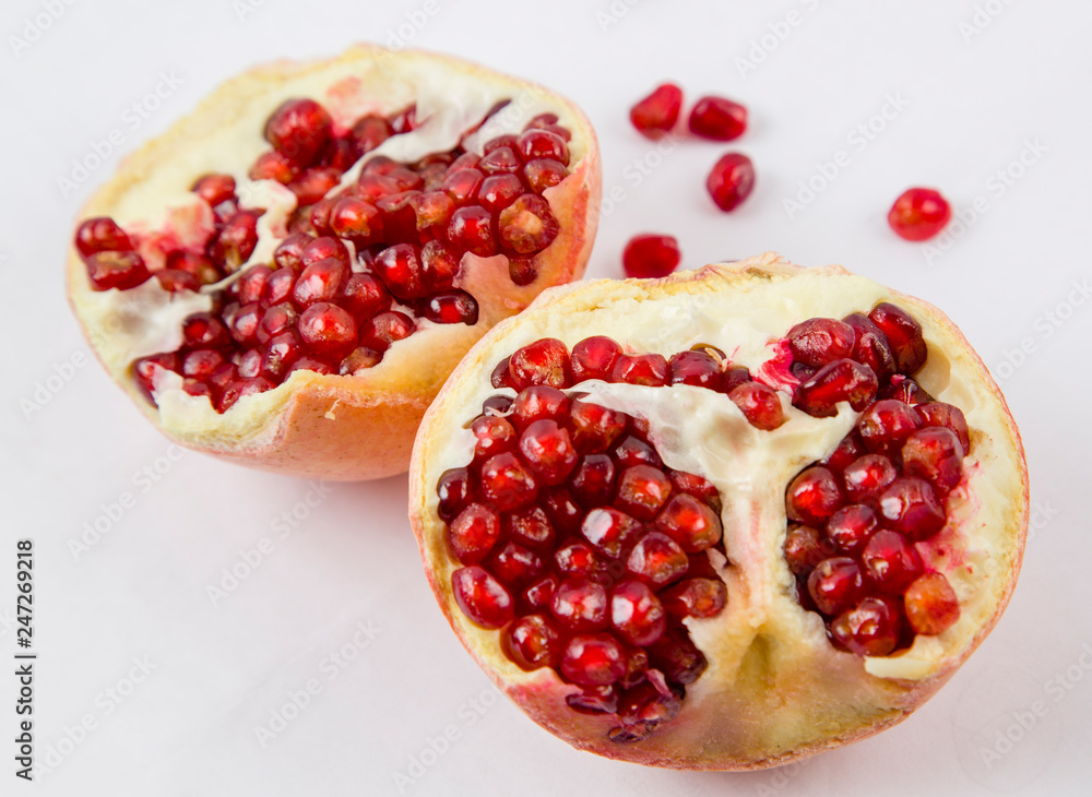 pomegranate broken, ripe red grains of pomegranate pomegranate broken, ripe red grains of pomegranate