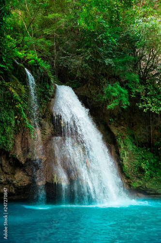 Kawasan waterfall in a mountain gorge in the tropical jungle of the Philippines, Cebu.