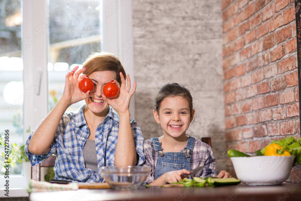 Mom and daughter cook together at home Mom and daughter cook together at home