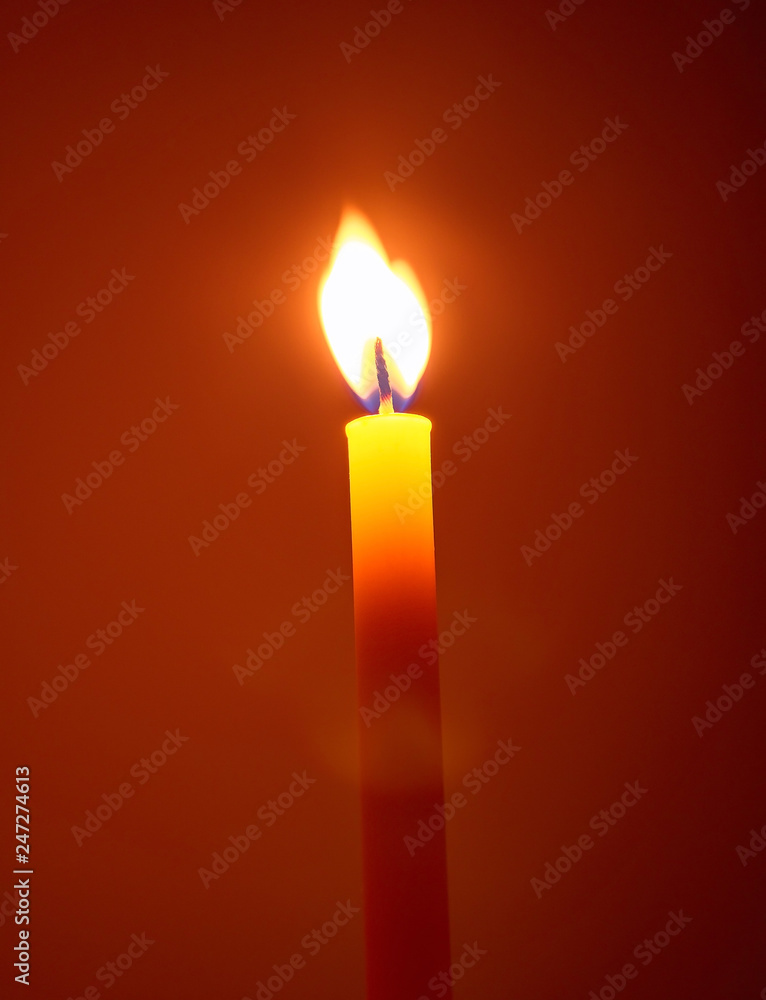candle in the dark, One candle flame at night. Candle lit in the dark. Design for the background. candle in the dark, One candle flame at night. Candle lit in the dark. Design for the background.
