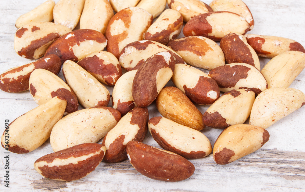 Heap of brazil nuts on rustic board Heap of brazil nuts on rustic board